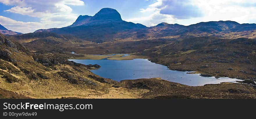 Mount Sulven with a small loch in the foreground in the Asynt region of the western highland of Scotland. Mount Sulven with a small loch in the foreground in the Asynt region of the western highland of Scotland