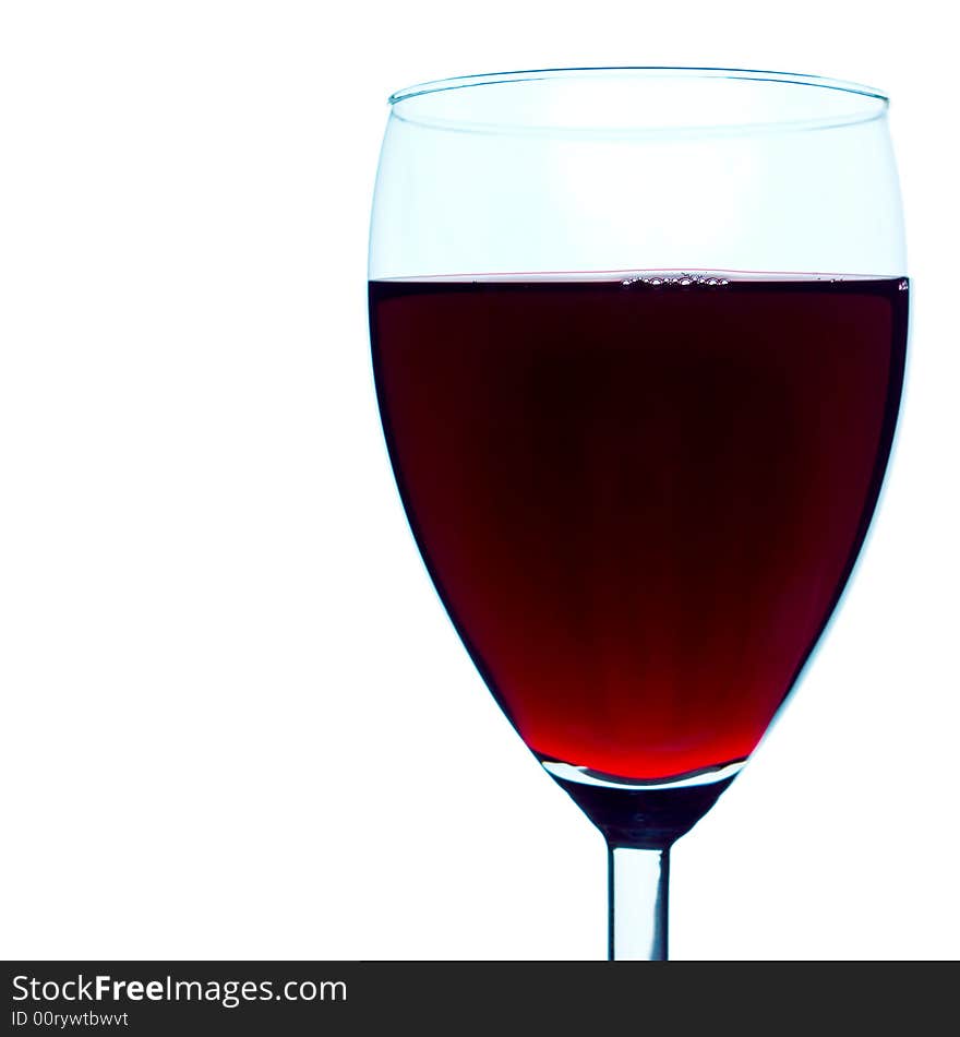 High-contrast studio shot of a back-lit red wine glass. Pure white background, very clean and sharp, a couple of bubbles clearly defined on the surface of the beverage