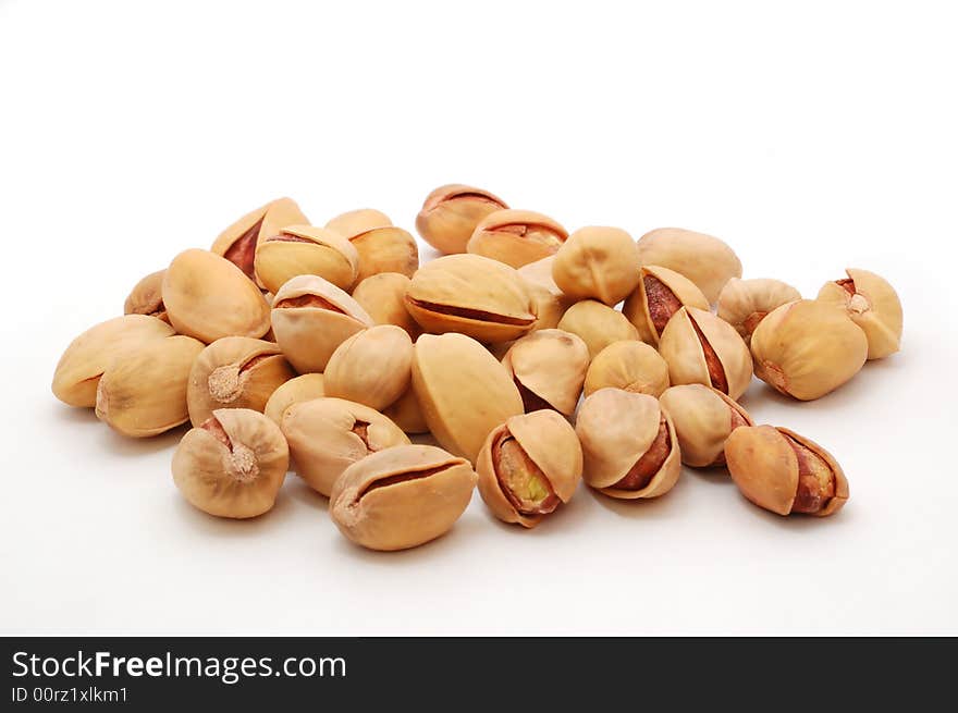 Heap of salted shelled pistachio on the white background. Heap of salted shelled pistachio on the white background