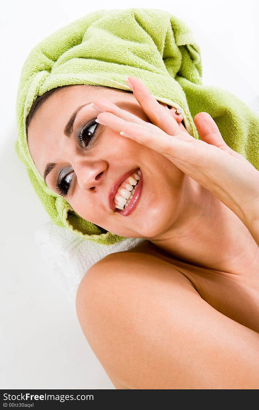 Woman with towel on head smiling to the side, Gentle overhand. Woman with towel on head smiling to the side, Gentle overhand.