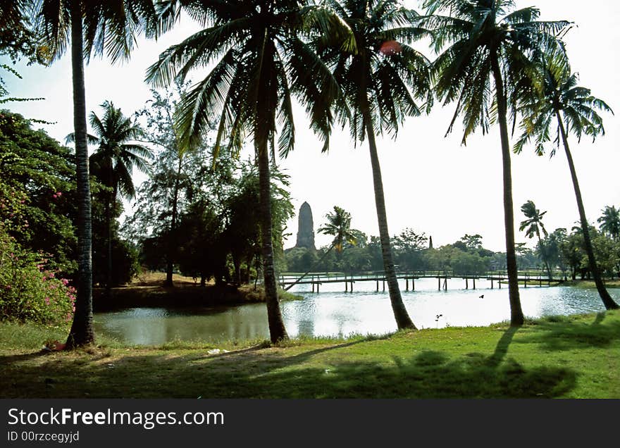 Lake-side Temple ruin with palm trees