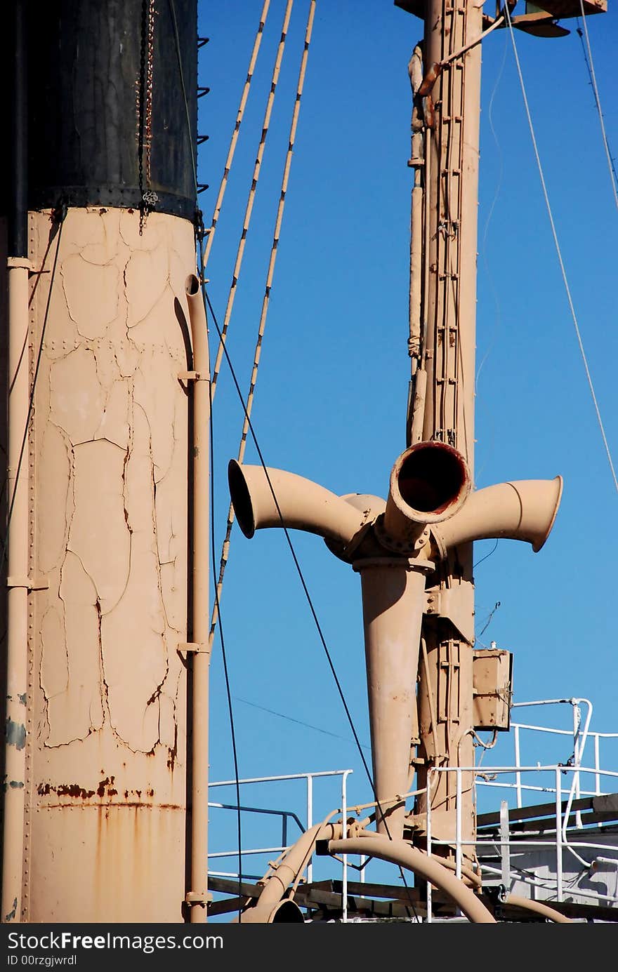 Antique boat riggings and portal lights against a blue sky. Antique boat riggings and portal lights against a blue sky