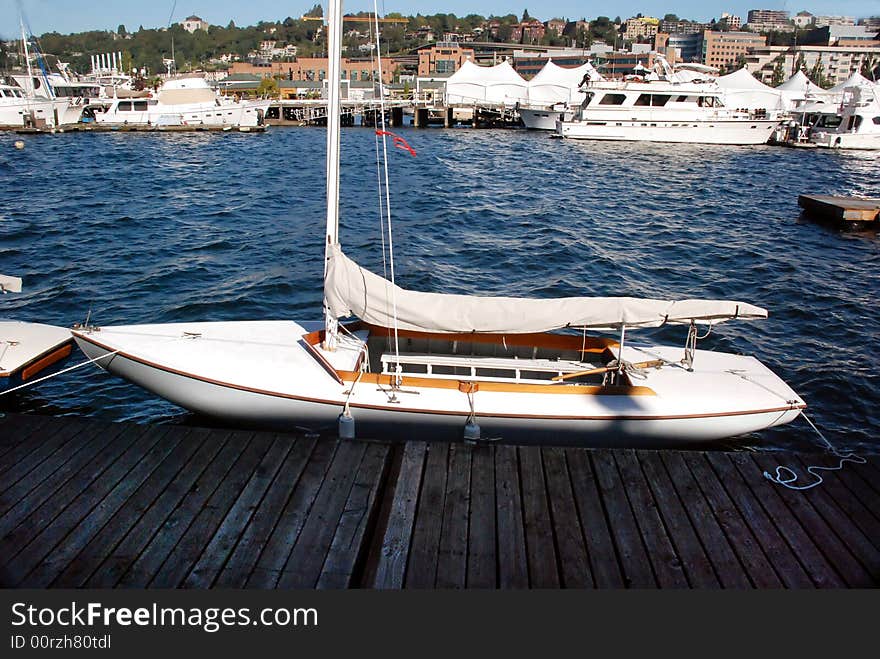 Sailboat on the water backdropped by city dweller homes