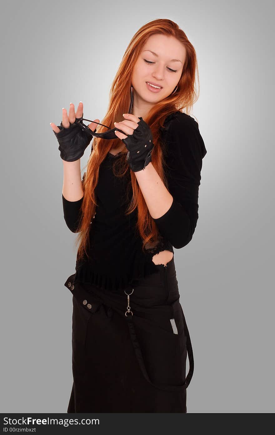 Beauty redhead girl in black clothes with sunglasses