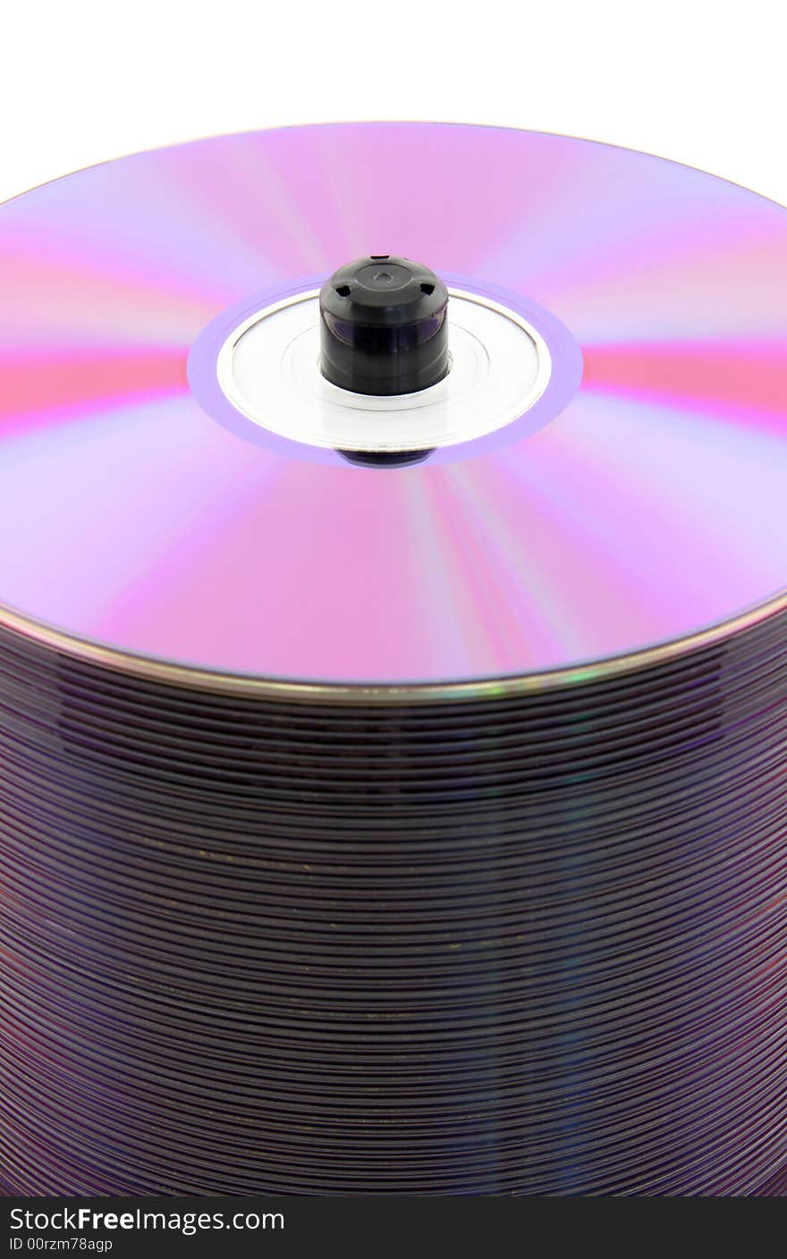 Purple CDs or DVDs on spindle, on white background. No dust. Purple CDs or DVDs on spindle, on white background. No dust.