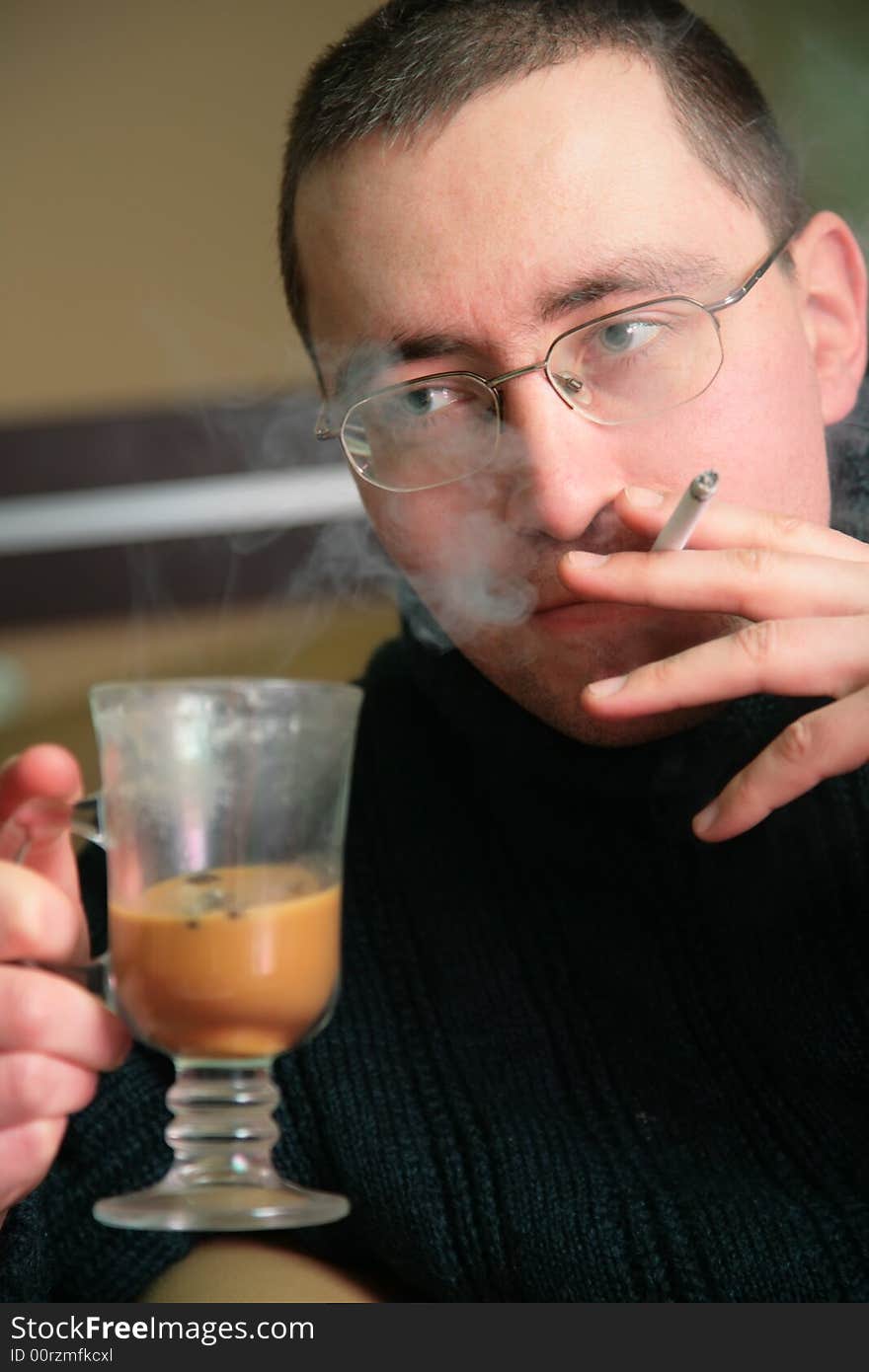 Man with glass and cigarette