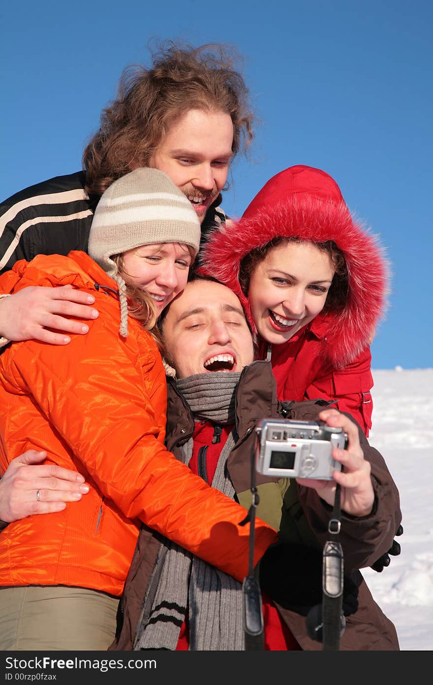 Group of friends taking photographs of themselves on a winter day. Group of friends taking photographs of themselves on a winter day.