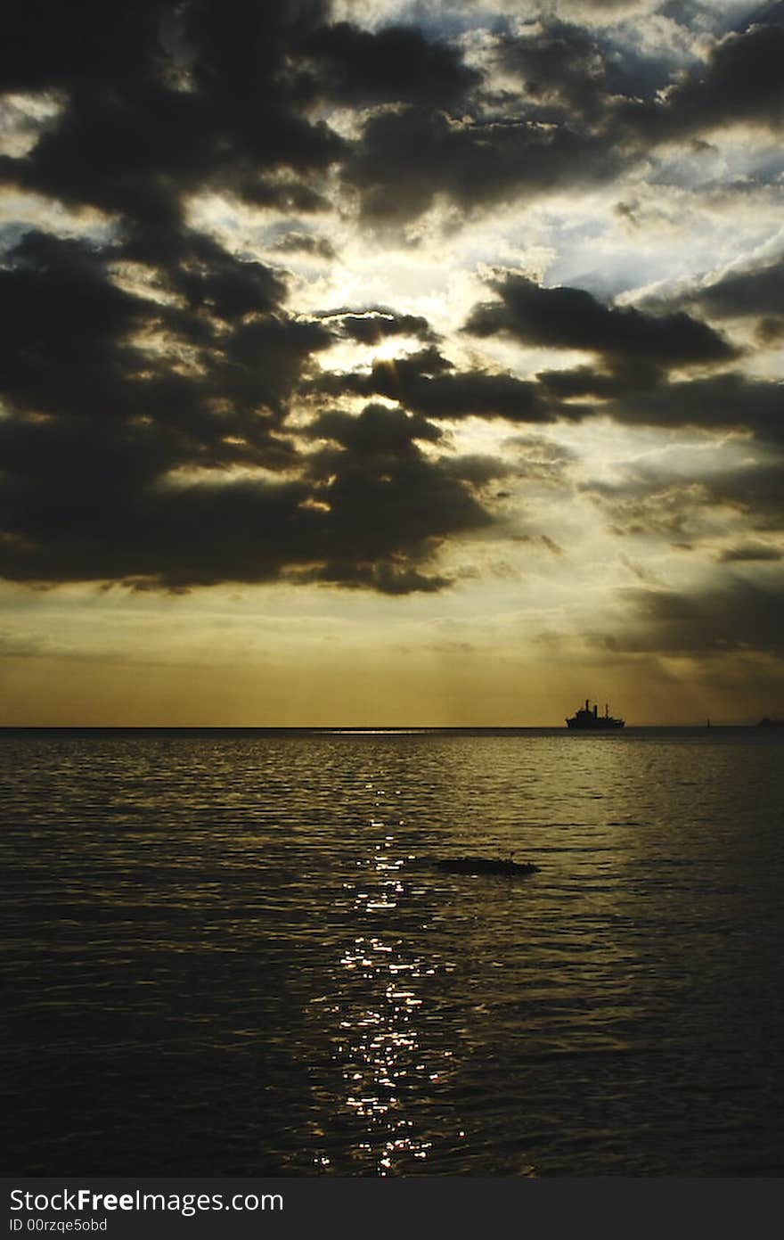 Sunset in Manila Bay with the light breaking through the clouds