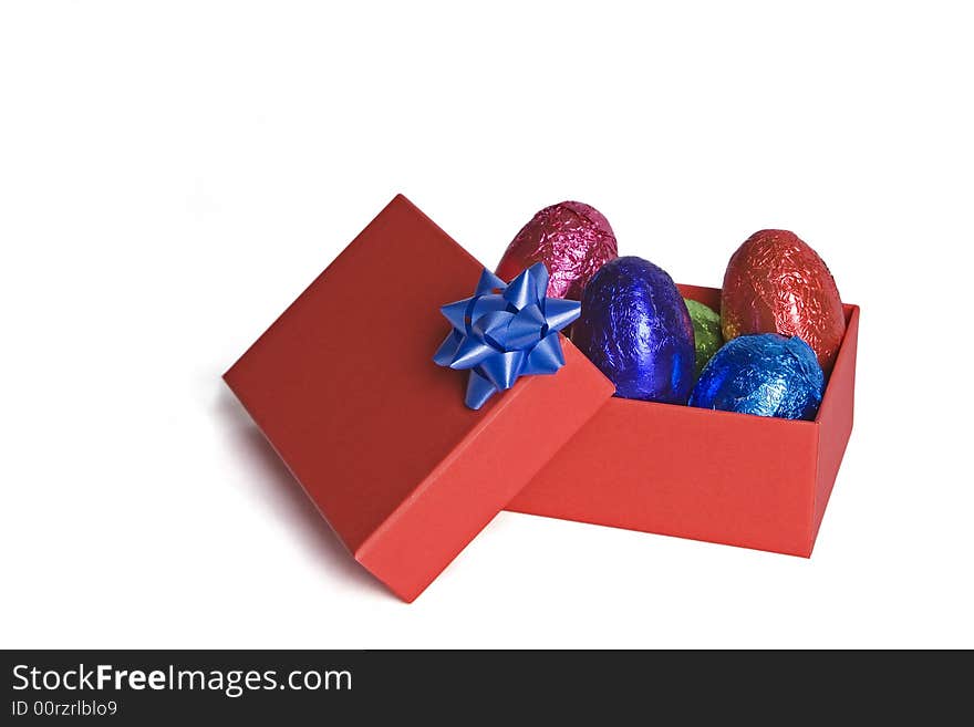 A red box of easter eggs in various colors. Perfect for easter greeting. A red box of easter eggs in various colors. Perfect for easter greeting.