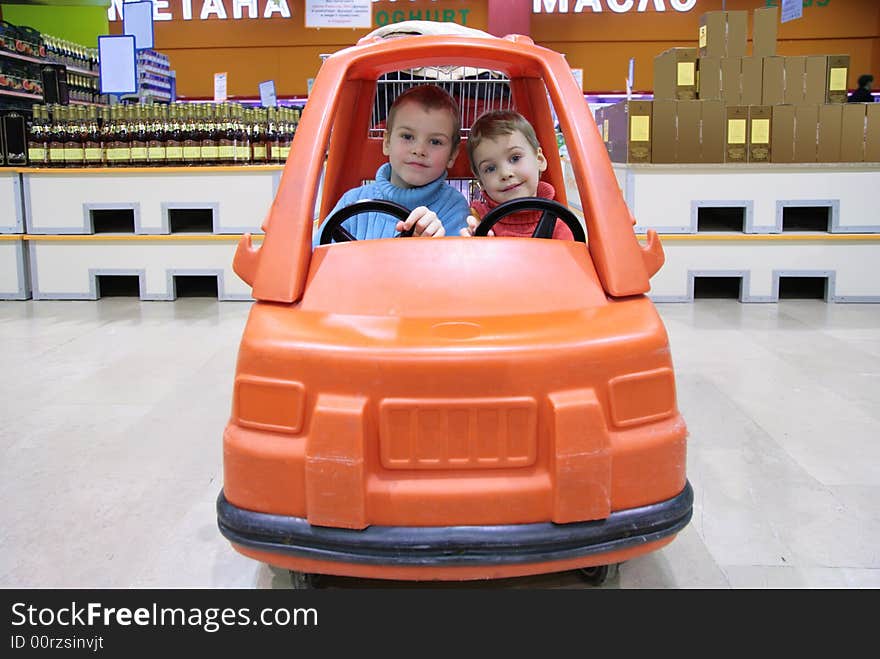 Children in toy automobile in supermarket 2. Children in toy automobile in supermarket 2