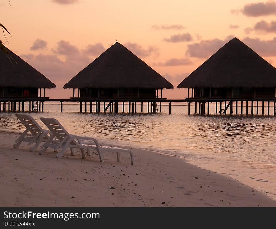 Sunset on the island beach with country houses. Sunset on the island beach with country houses