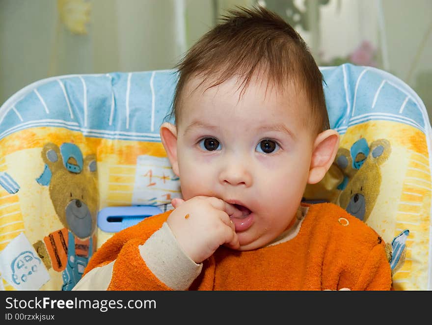 The small child sits at a children's little table. The small child sits at a children's little table