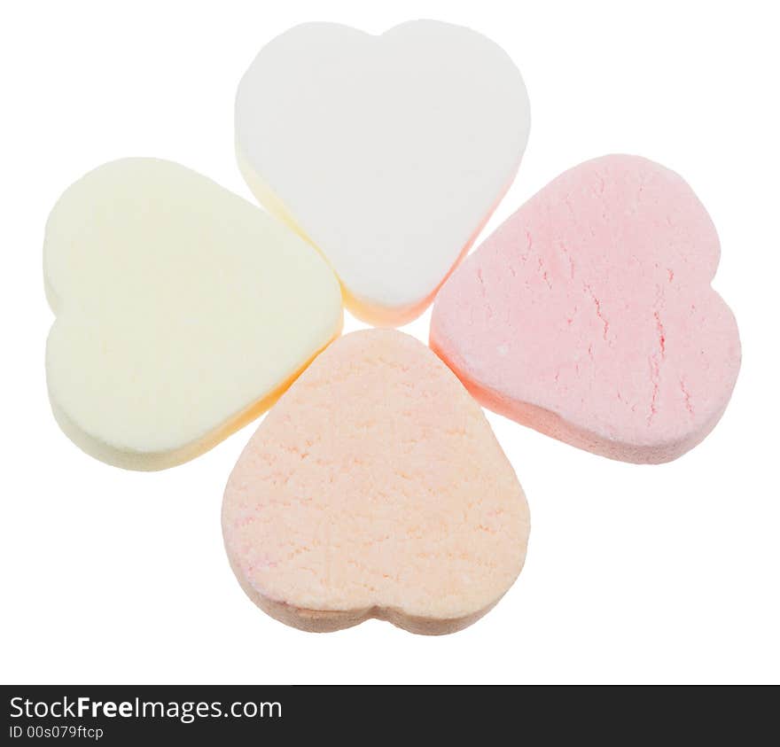 Candy heart shaped sweets in a clover shape (lucky in love) isolated on a white background