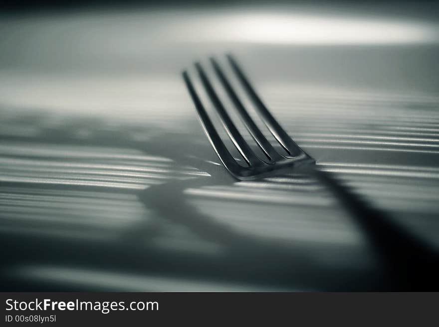 A fork lightened under filtered light