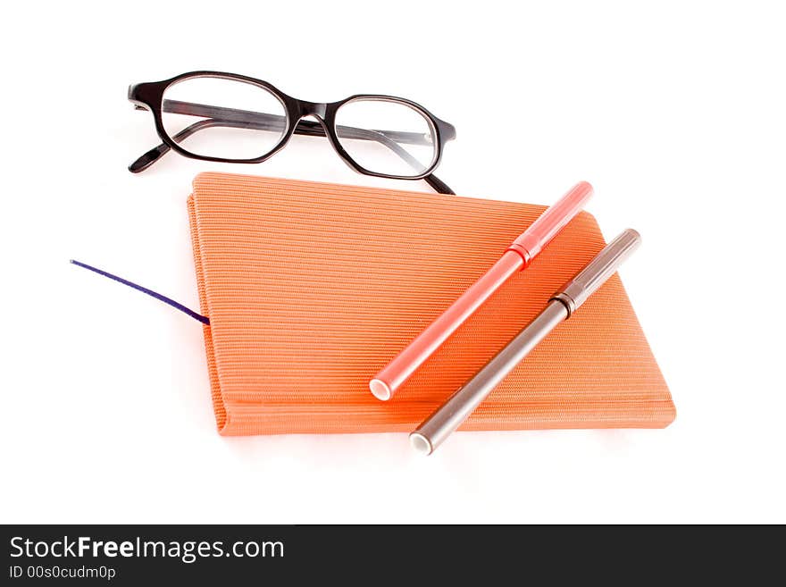 Red book, black glasses and markers