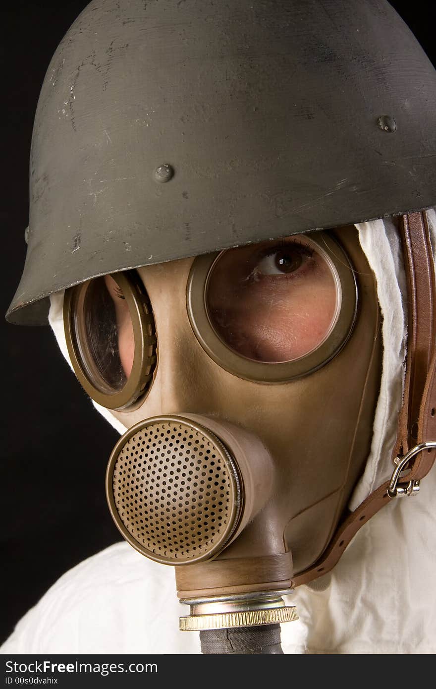 Woman in gas mask and helmet on black background