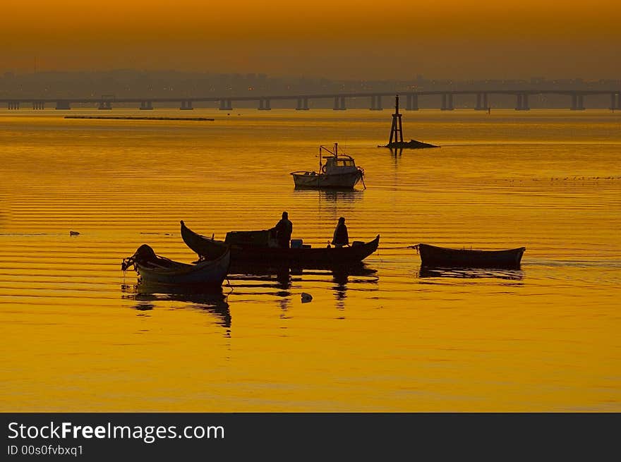 Fishing boats anchorage harbour  by sunset at River Tagus Estuary, Alcochete, Portugal, EU. Fishing boats anchorage harbour  by sunset at River Tagus Estuary, Alcochete, Portugal, EU.