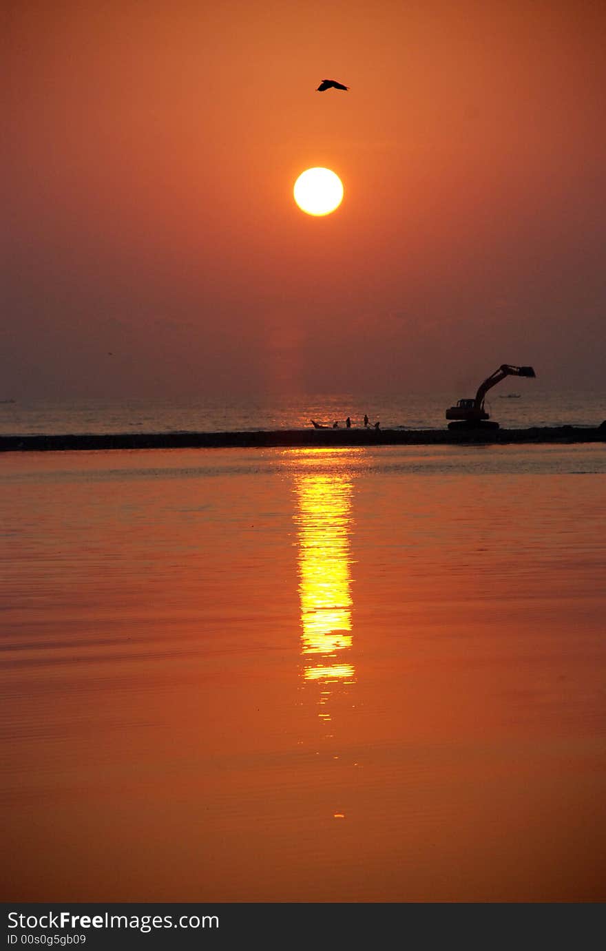 Coastal cleaning work is going on while they sunrise