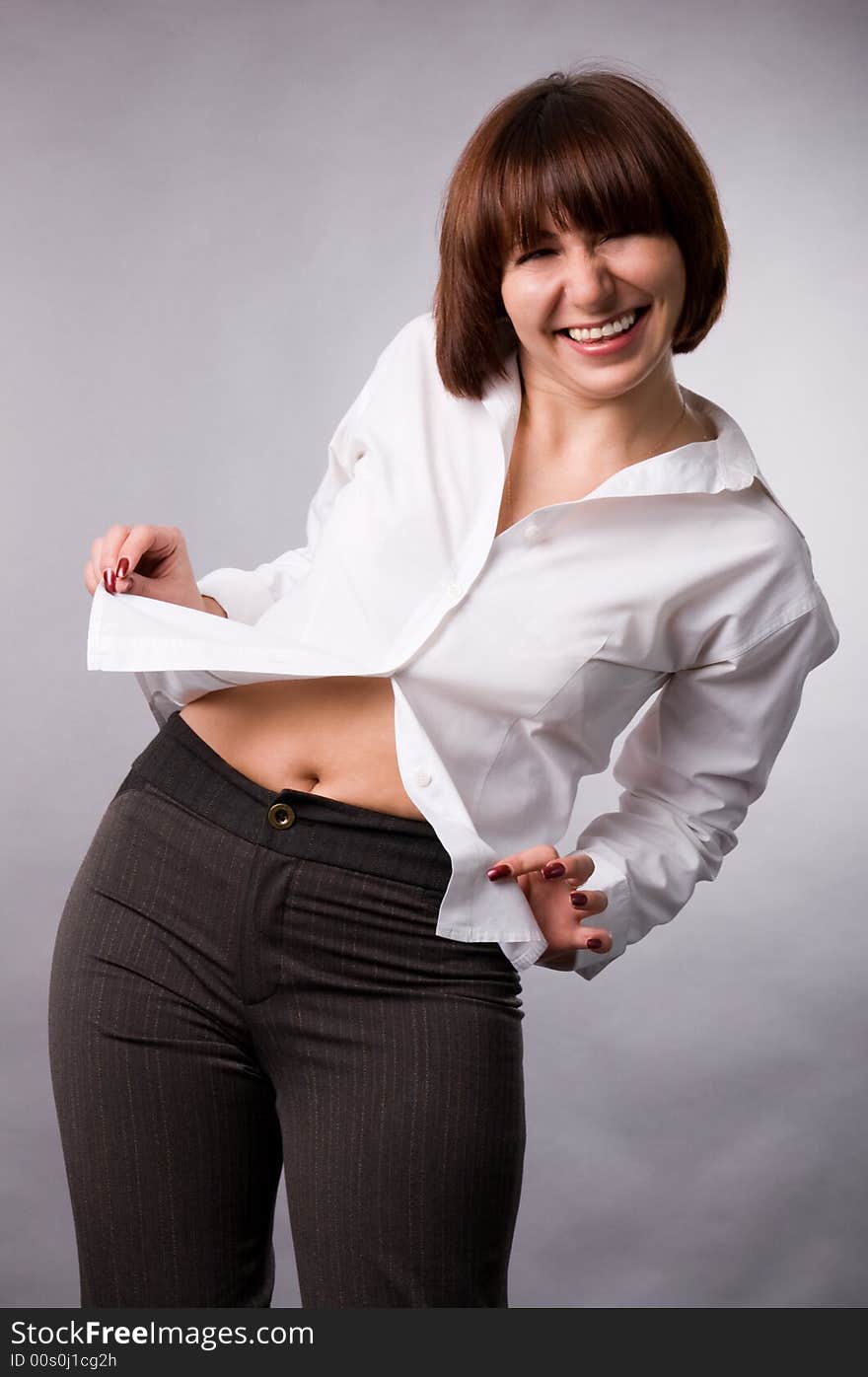 The woman in a white shirt on a grey background