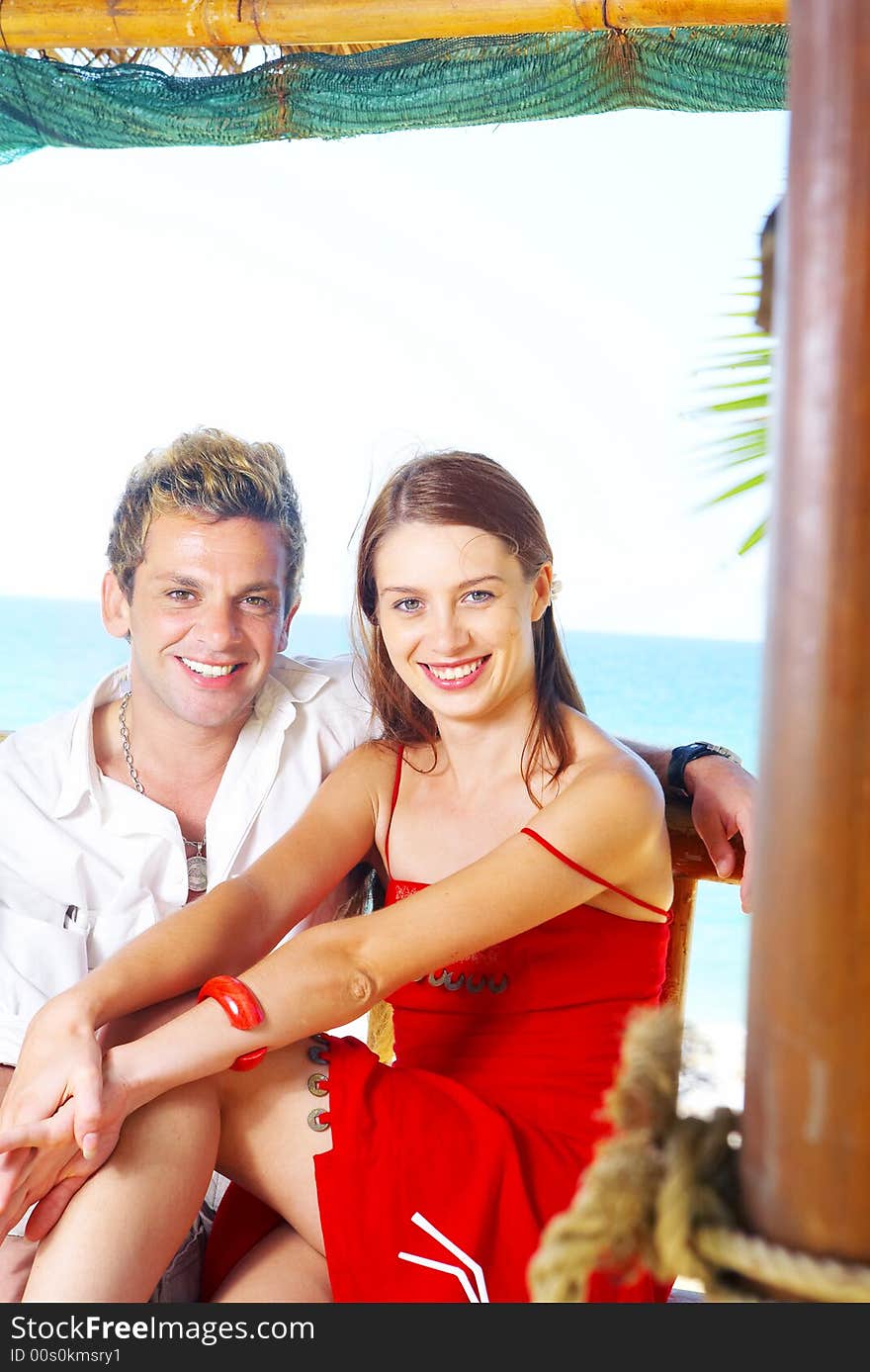 A portrait of attractive couple having fun on the beach. A portrait of attractive couple having fun on the beach