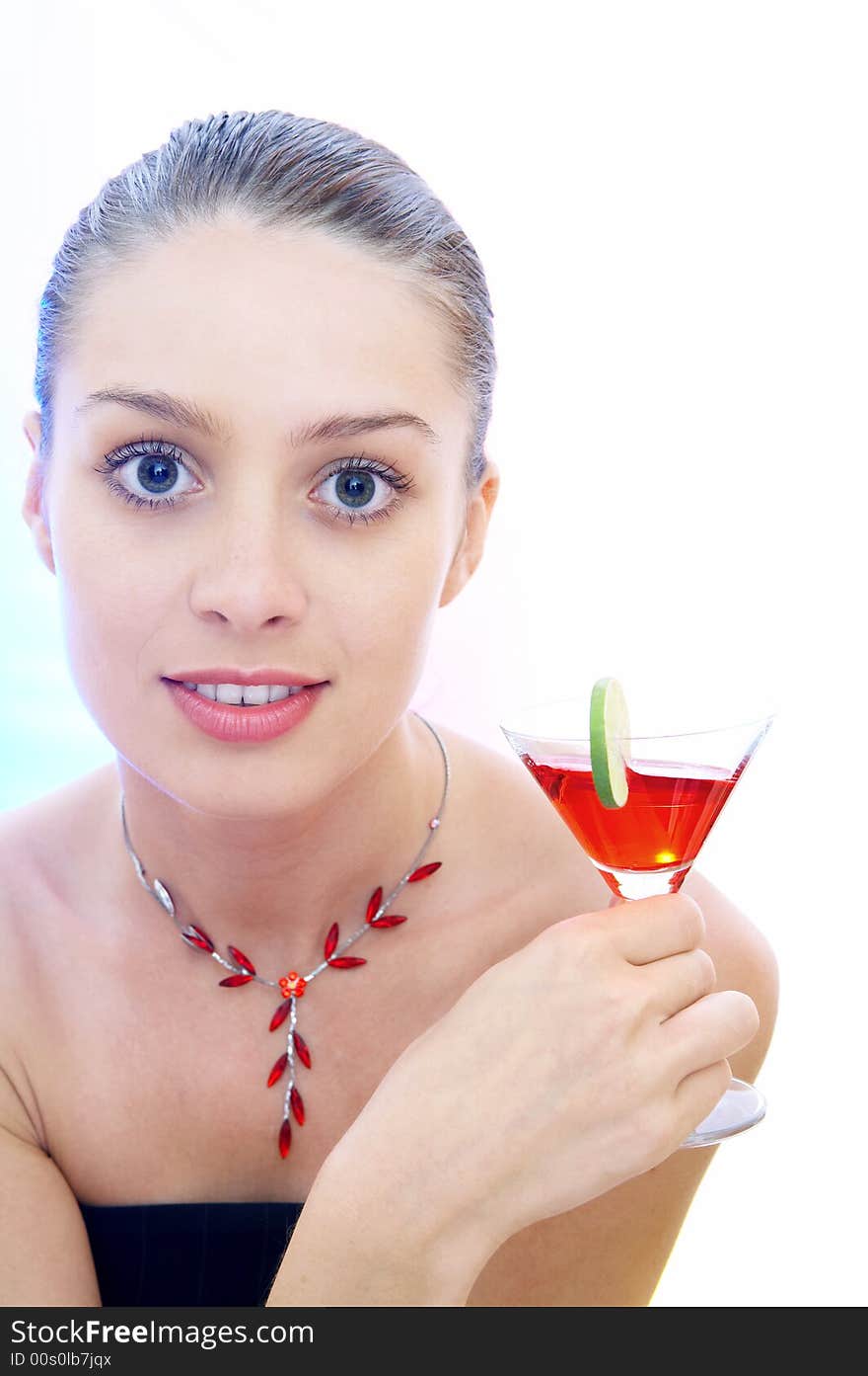 High-key portrait of young woman with cocktail  in multicolor back lights. Image may contain slight multicolor aberration as a part of design