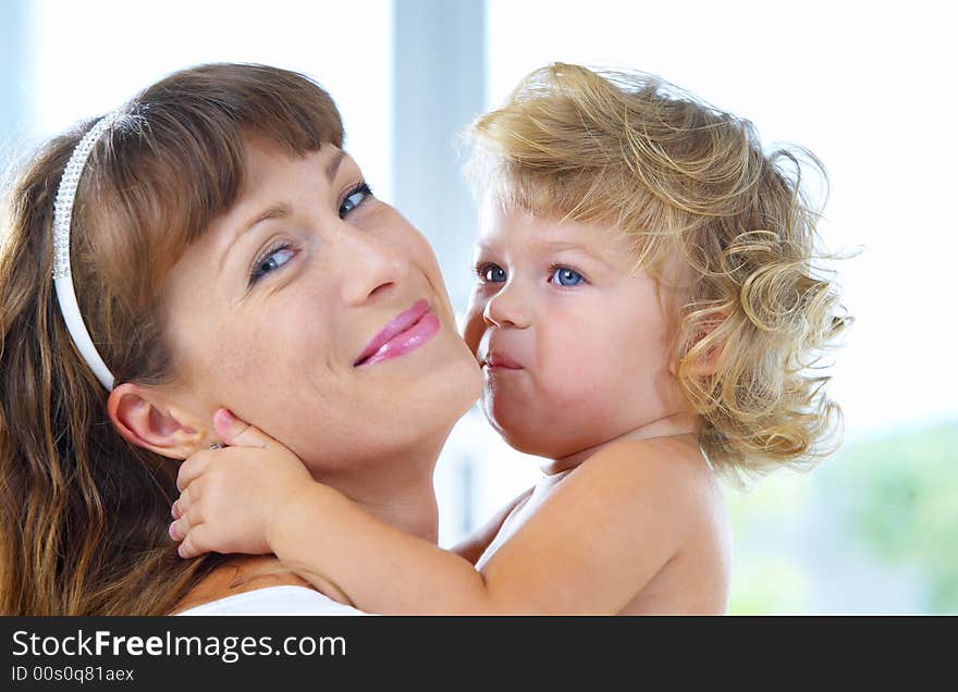 High key portrait of happy mother with baby. High key portrait of happy mother with baby