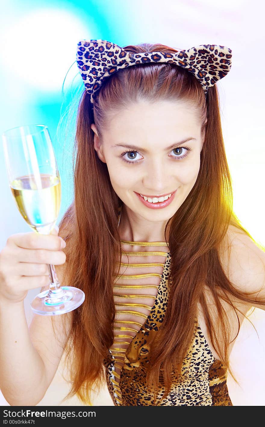 High-key portrait of young woman with glass of champagne  in multicolor back lights. Image may contain slight multicolor aberration as a part of design