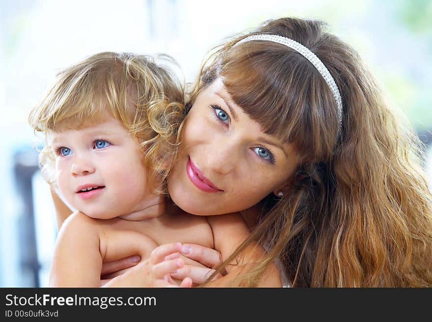 High key portrait of happy mother with baby. High key portrait of happy mother with baby