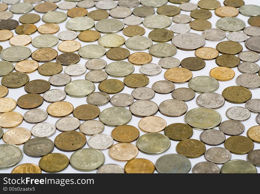 Field of coins on white background, focus on center of image