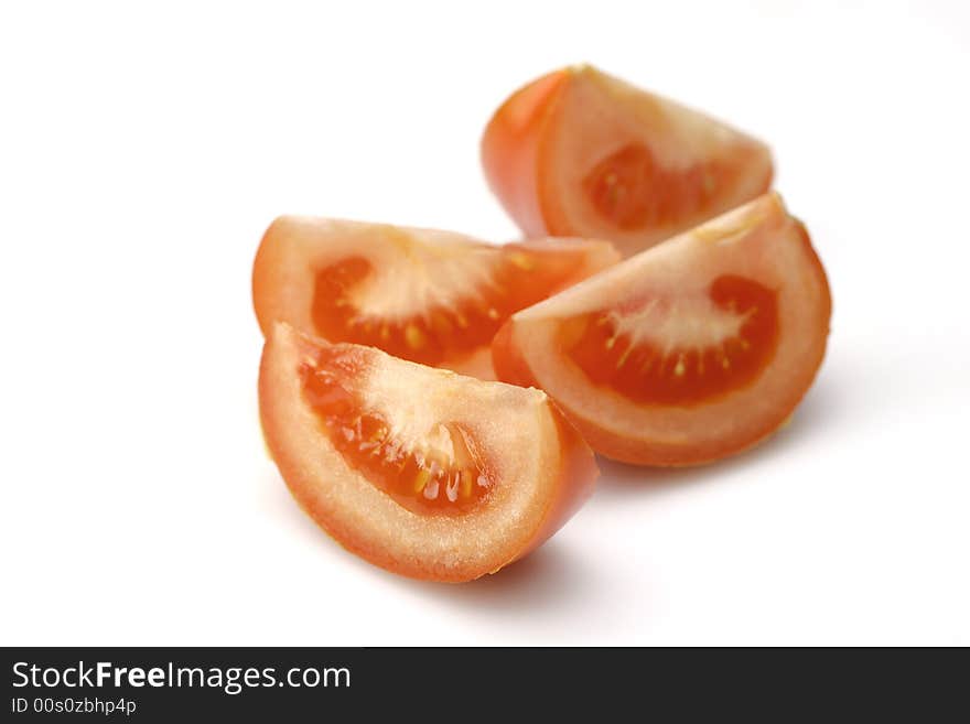 Pieces of tomatoes on white