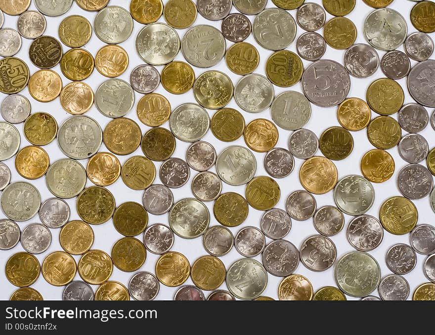 Field of coins on white background, view from above