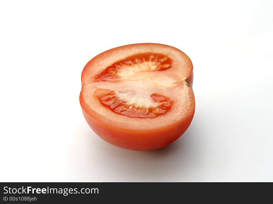 Half of tomato on white