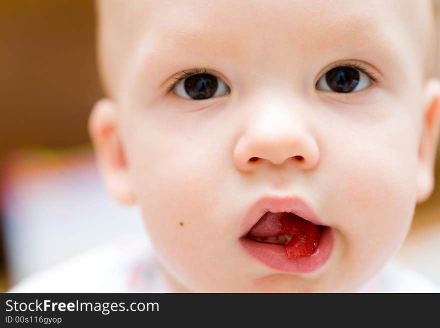 Baby eating apple. Children's face close-up