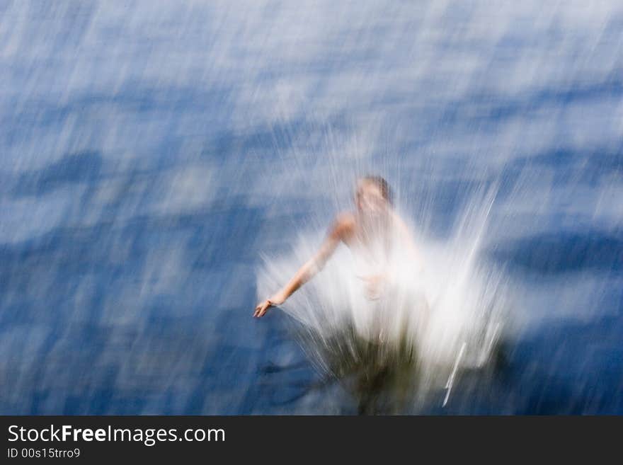 A boy falling into water. It´s a abstract photo made with slow shutter speed causing a blur effect. A boy falling into water. It´s a abstract photo made with slow shutter speed causing a blur effect.