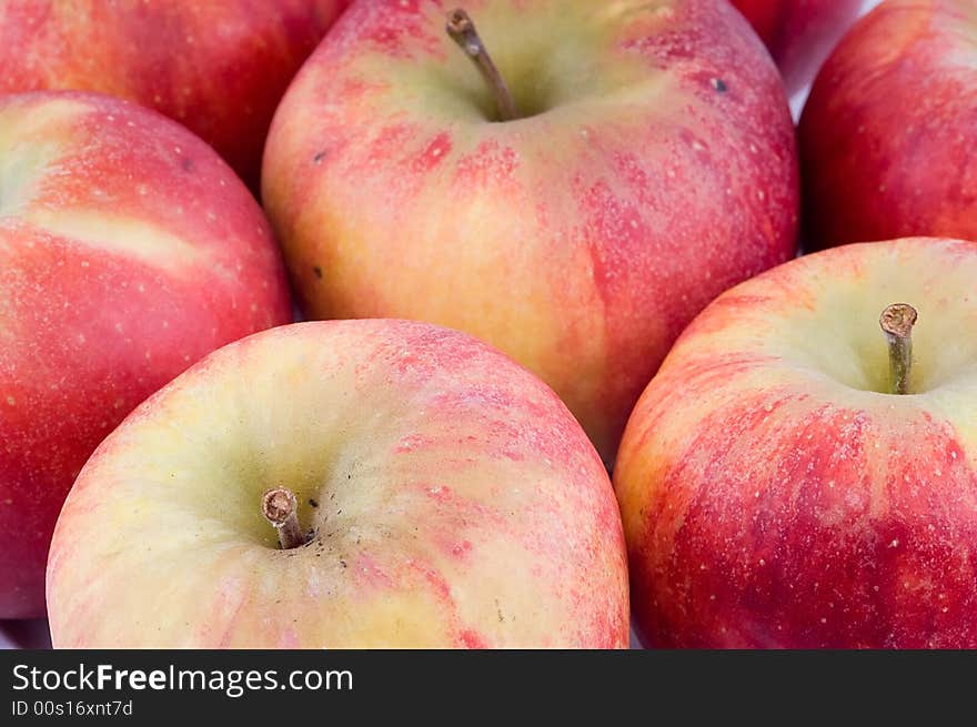 Close-up on fresh red apples on white background.