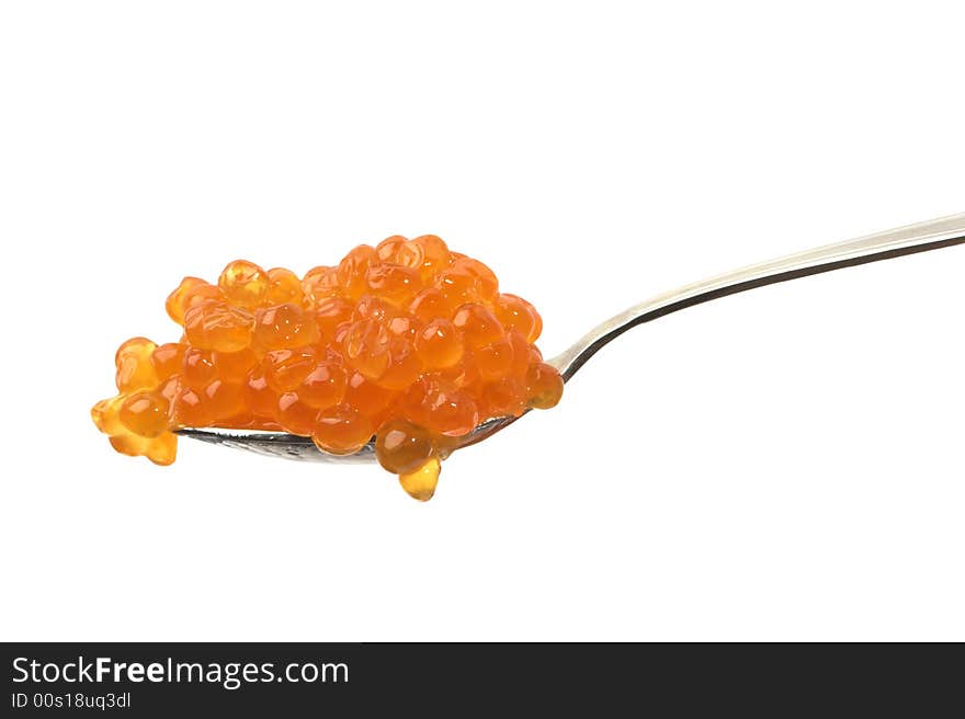 Red caviar on a spoon, isolated on white.