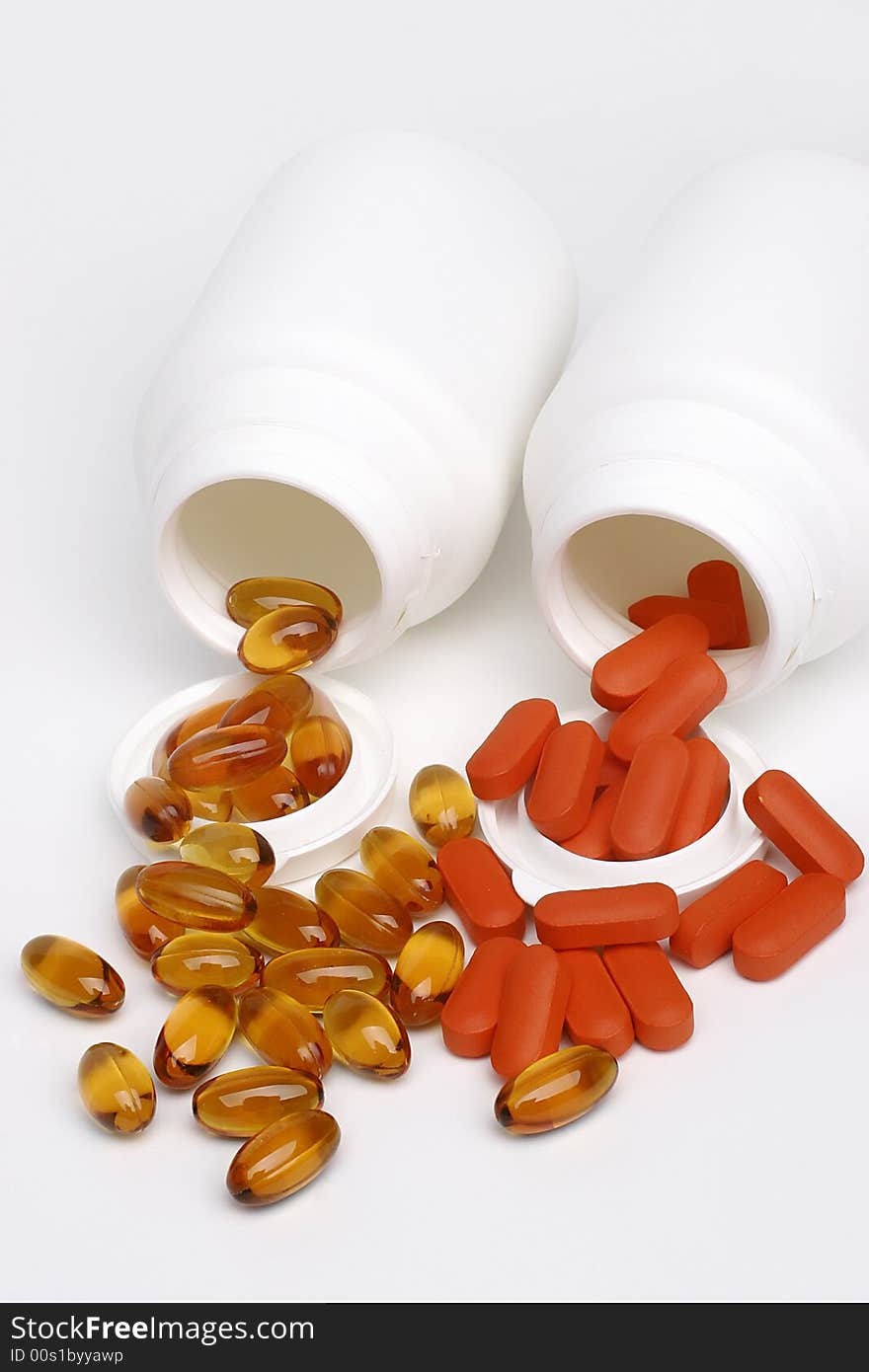 Two bottle with orange and brown pills