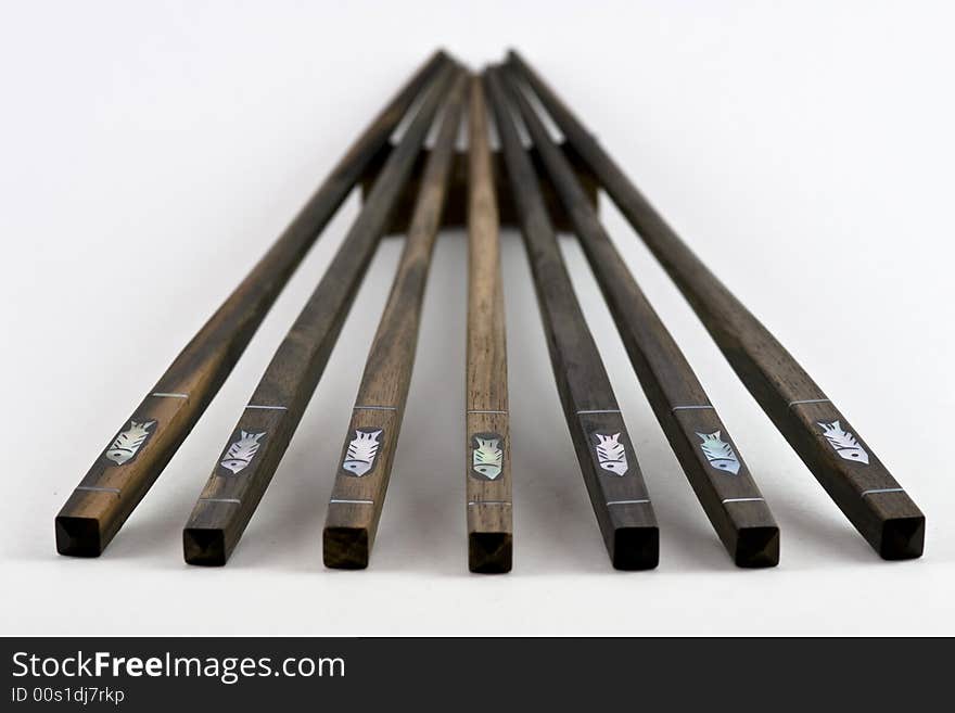 Seven chopsticks lined up in a fan shape. Seven chopsticks lined up in a fan shape