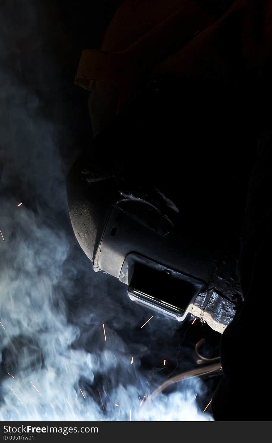 A welder working at shipyard at night. A welder working at shipyard at night