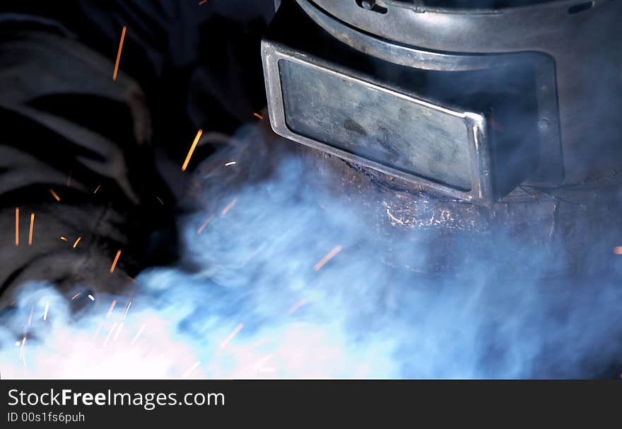 A welder working at shipyard at night. A welder working at shipyard at night