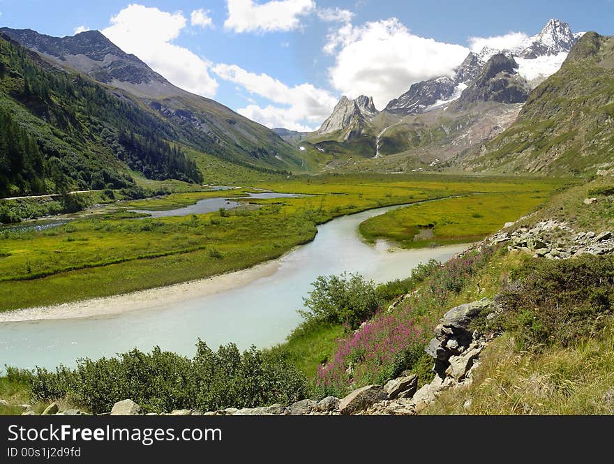 Val Veny,river Dora di Veny with background mountain Aiguille des Glaciers and Piramides Calcaires