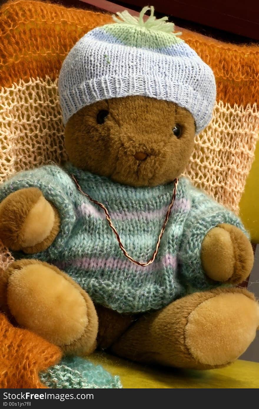 Macro of a Brown Teddy Bear in Winter sweater and hat. Macro of a Brown Teddy Bear in Winter sweater and hat