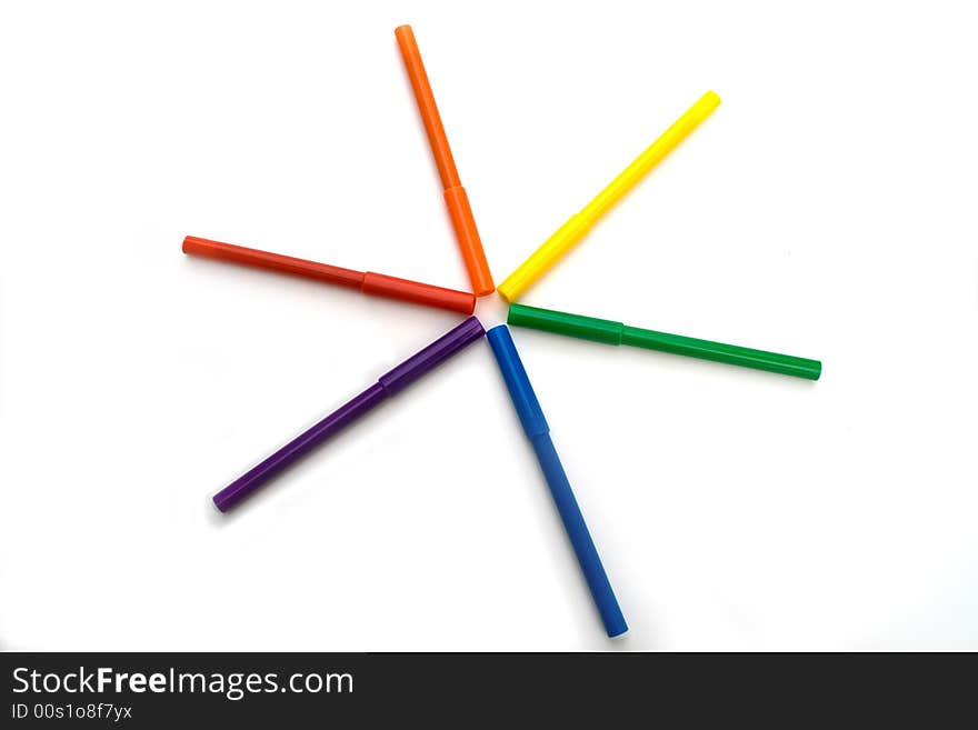 Rainbow colored markers against white background