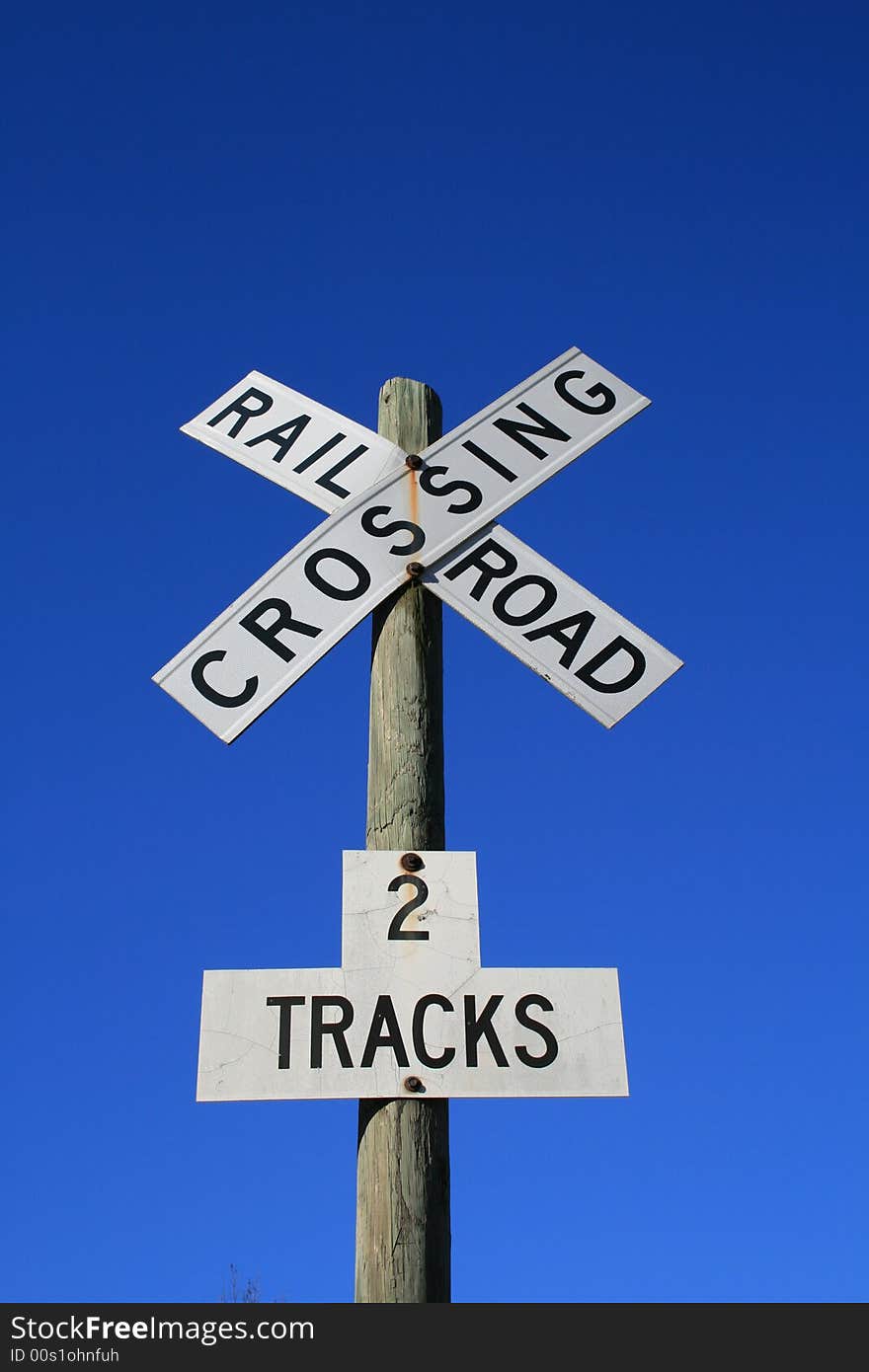 Railroad Crossing sign against a blue sky. Railroad Crossing sign against a blue sky