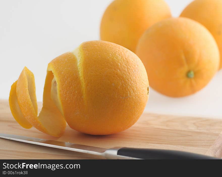 Peeled orange and knife