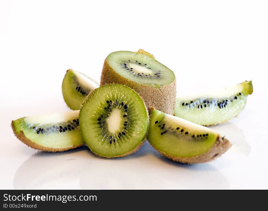 Colorful kiwi fruit whole and cut by four pieces