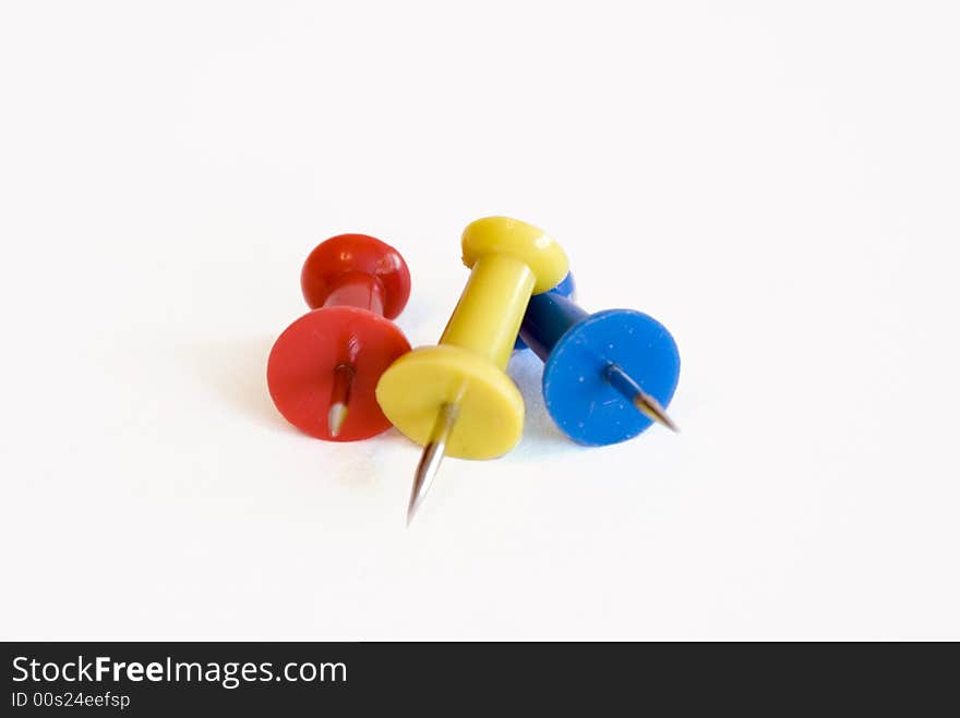 Stationary pins of three colors isolated on white background. Stationary pins of three colors isolated on white background