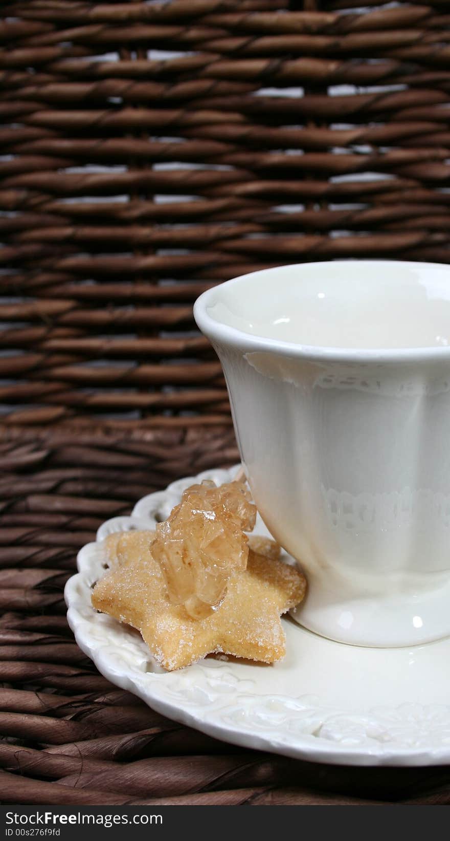 Cup and saucer with star shaped biscuits. Cup and saucer with star shaped biscuits