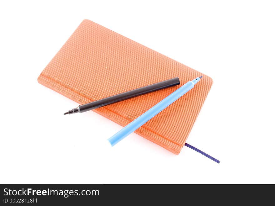 Red book and markers isolated on a white background