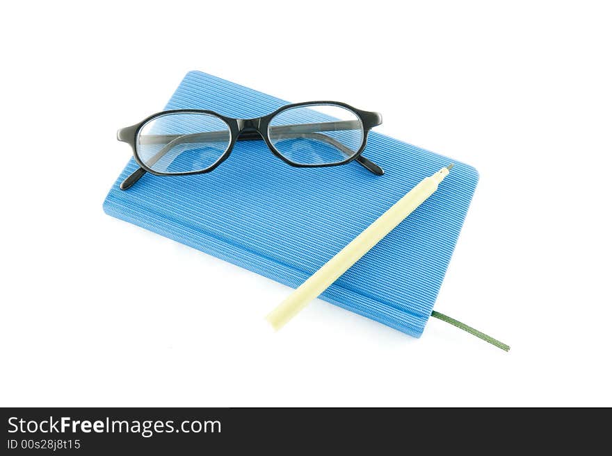 Blue book, black glasses and marker on a white background. Blue book, black glasses and marker on a white background